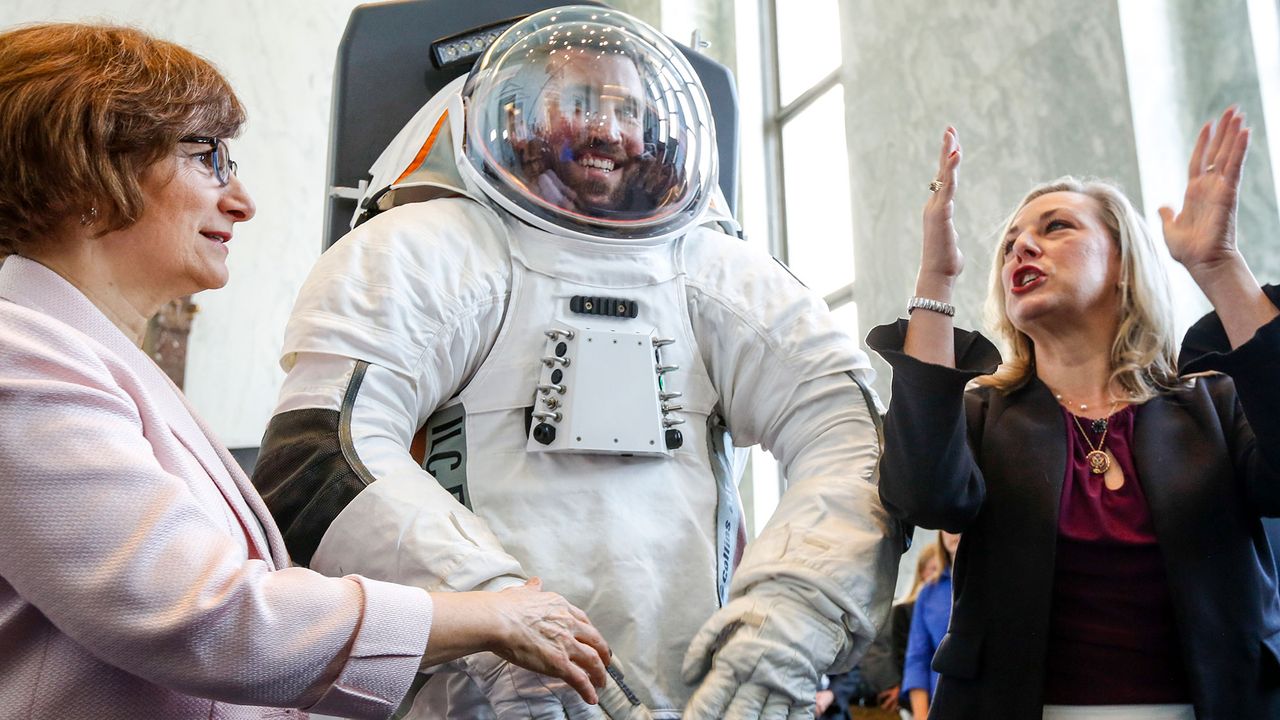 Rep. Suzanne Bonamici (D-OR), left, and Rep. Kendra Horn (D-OK), join an engineer inside the prototype of Collins Aerospace, a unit of United Technologies Corp.'s Next Generation Space Suit system, unveiled during the Space Day on the Hill on Thursday, July 25, 2019 in Washington. The showcase was timed to commemorate the 50th Anniversary of Apollo 11.