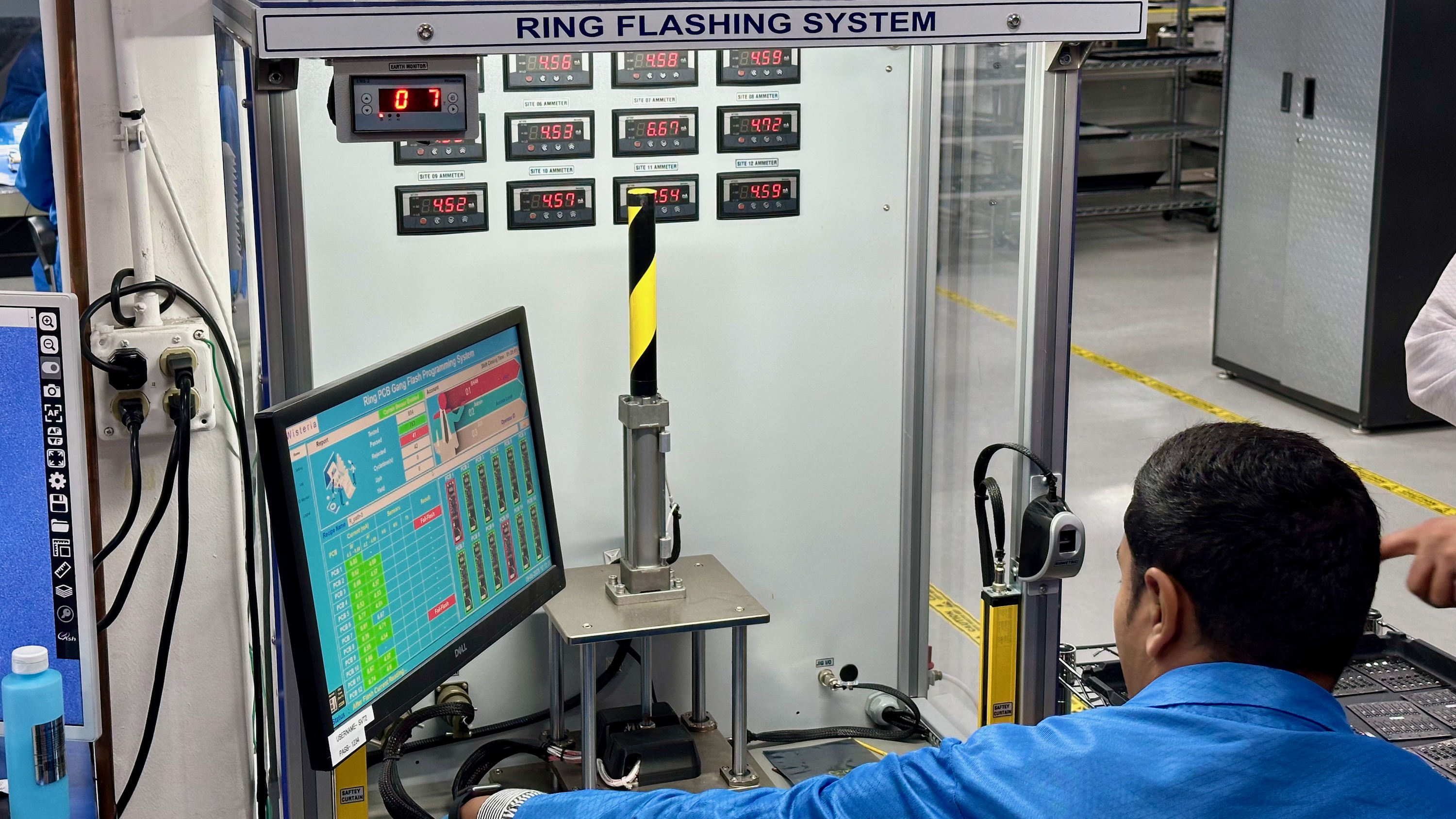 An Ultrahuman factory worker at the PCB Programming station, where they add the software that powers the Ring Air.