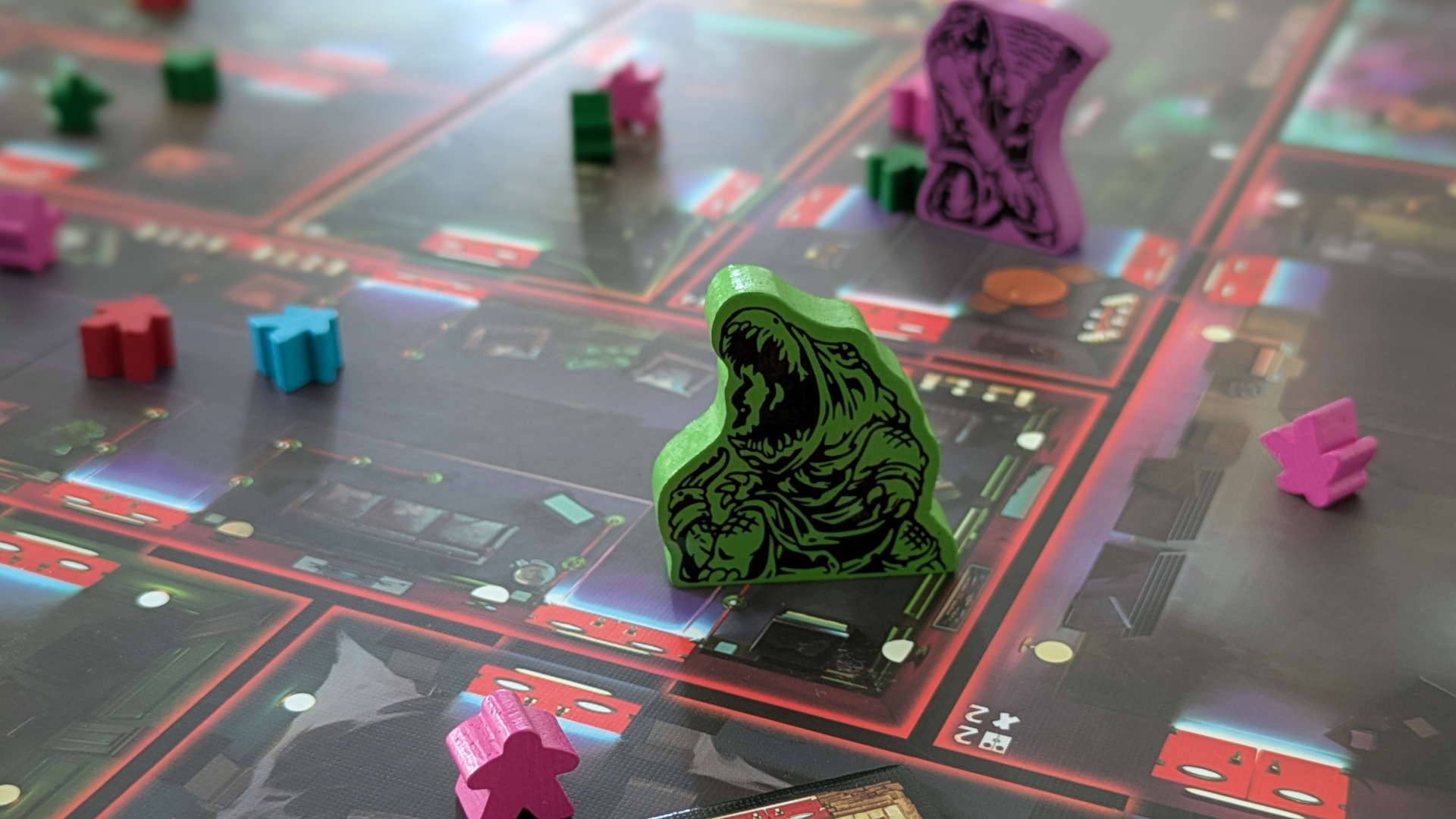 Spooktacular tokens laid out on the board, surrounded by meeple