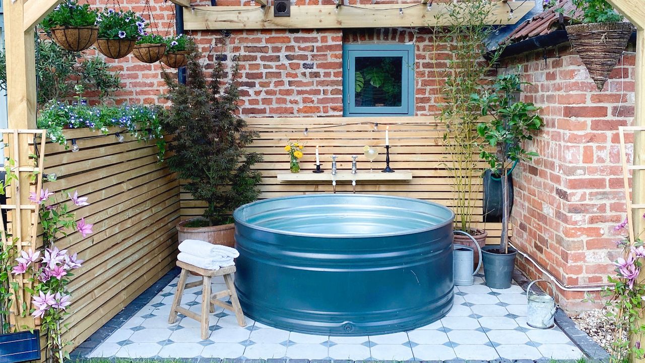 Stock tank pool on tiled patio in back garden space