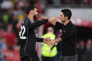 David Raya of Arsenal and Mikel Arteta, Manager of Arsenal, interact following their sides victory in the Premier League match between Arsenal FC and Manchester City at Emirates Stadium on October 08, 2023 in London, England. (Photo by David Price/Arsenal FC via Getty Images)