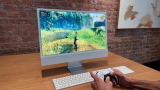 Gaming on an Apple iMac with a PlayStation DualSense Controller.