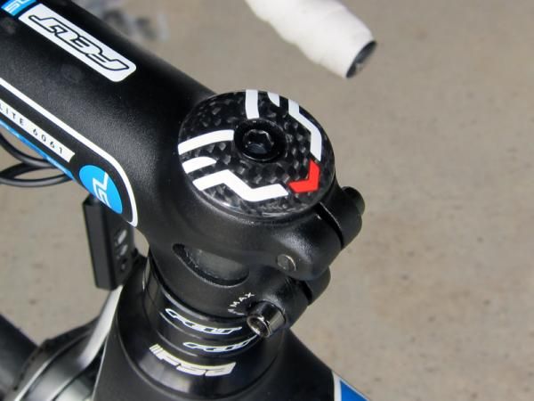 The carbon fiber stem cap is anchored in place with a surprisingly short alloy bolt