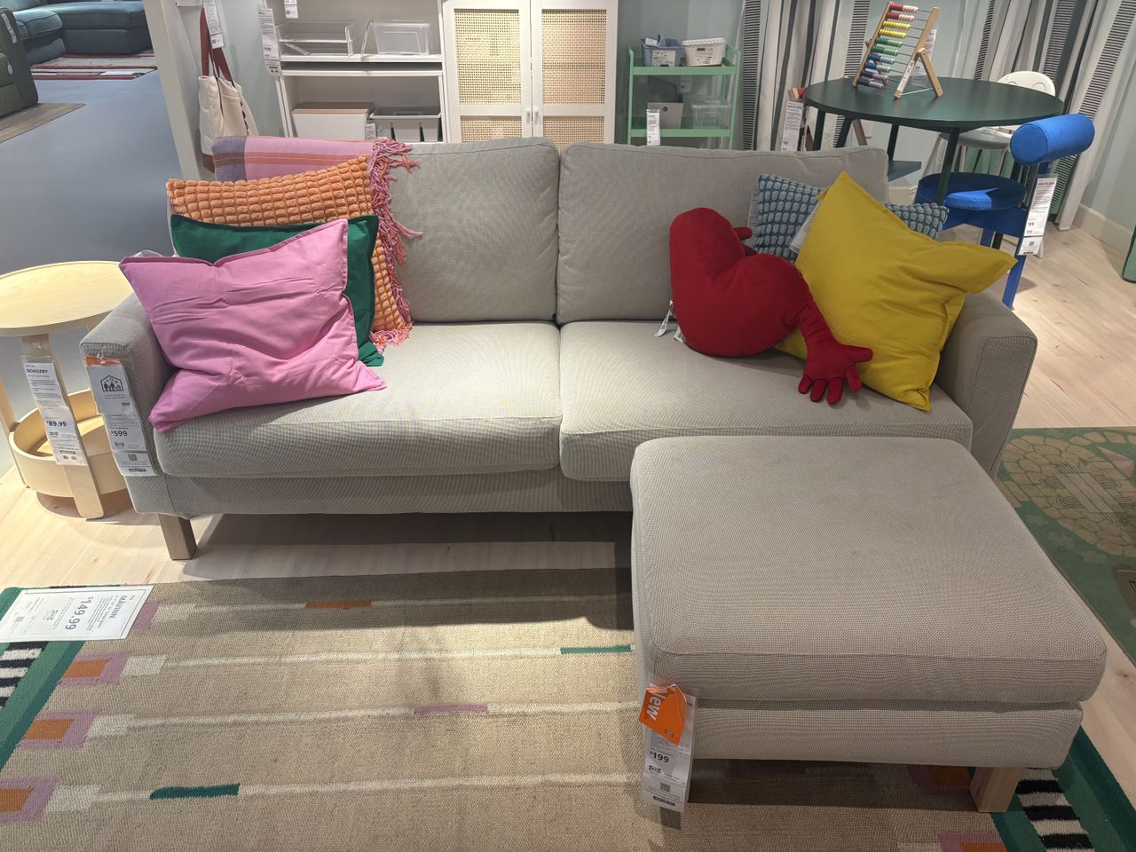 A beige gray sofa sits in a showroom.