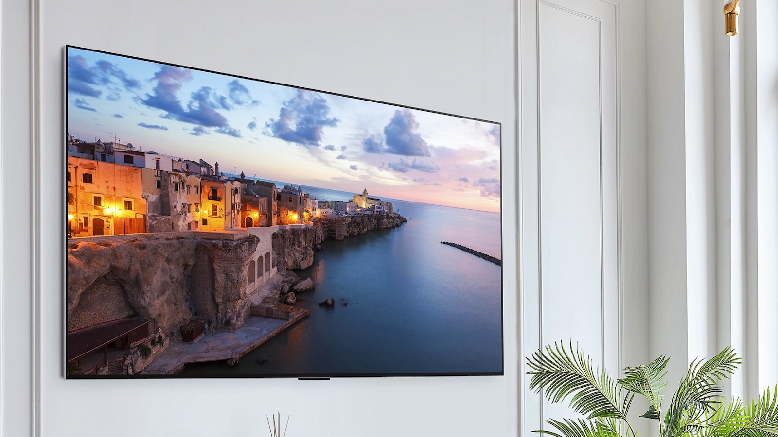 A wall-mounted TV displaying an urban landscape