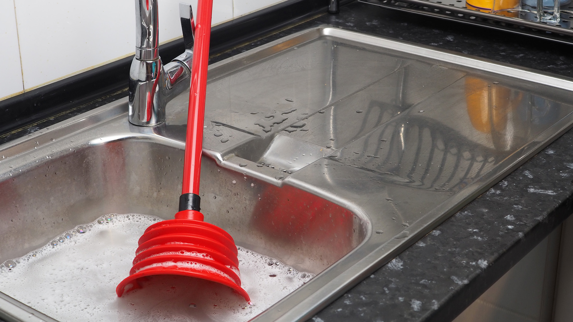 Sink plunger in kitchen sink