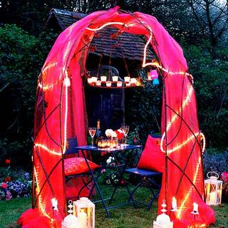 pink fabric gazebo with hanging lanterns