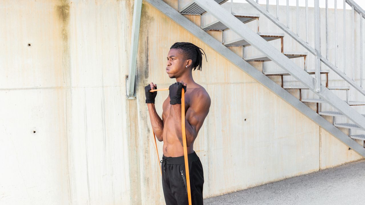 A man exercising with a resistance band 