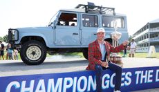 Ben Griffin poses with the trophy in front of a Land Rover and trophy