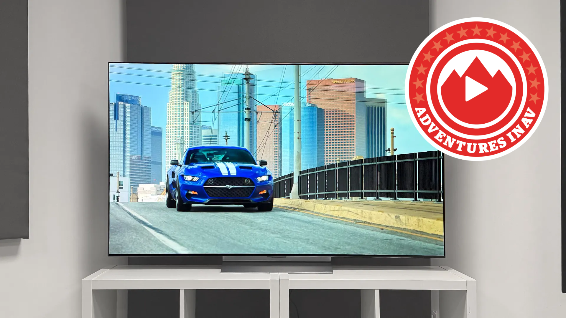 An LG C6 OLED TV with a muscle car on screen and a logo that reads "Adventures in AV"