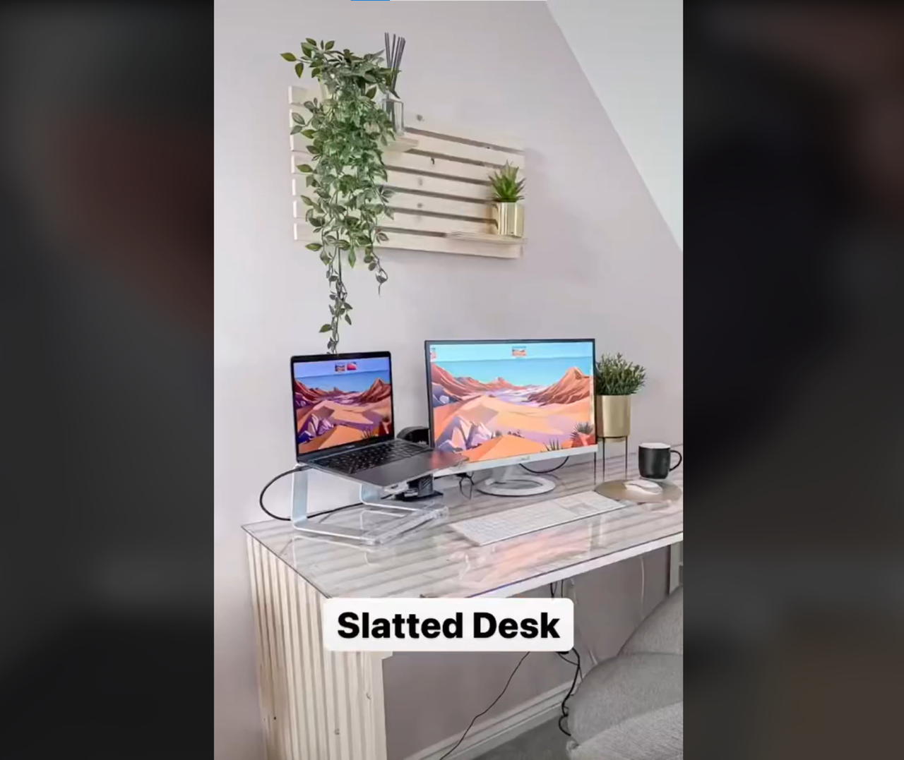 DIY see through desk with laptop and computer standing on top with planter hanging on the wall