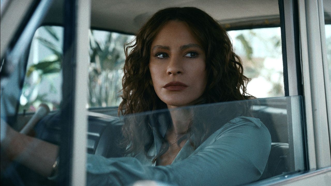 a woman (sofia vergara as griselda) looks out of a car window