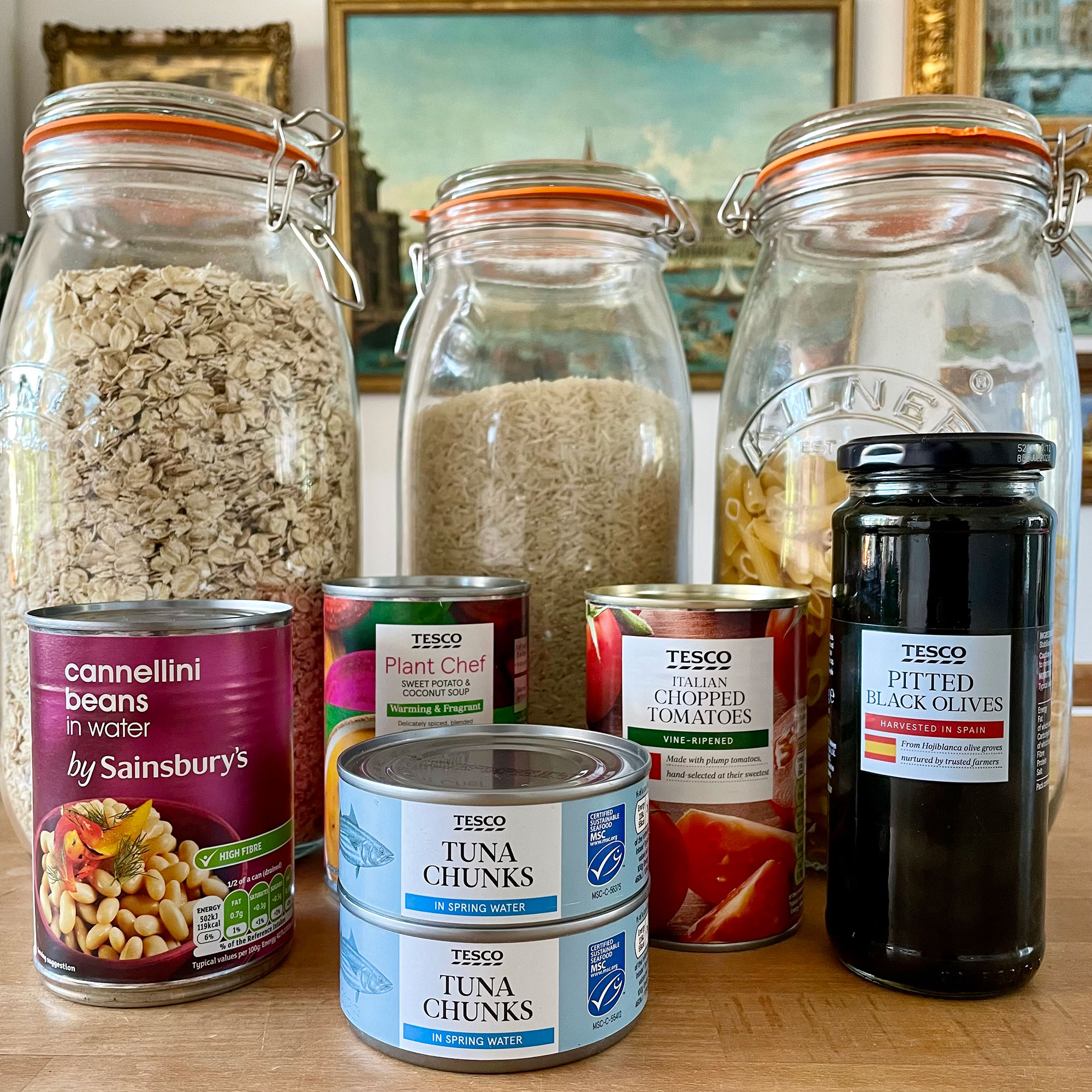 Array of tins and jars of food on table