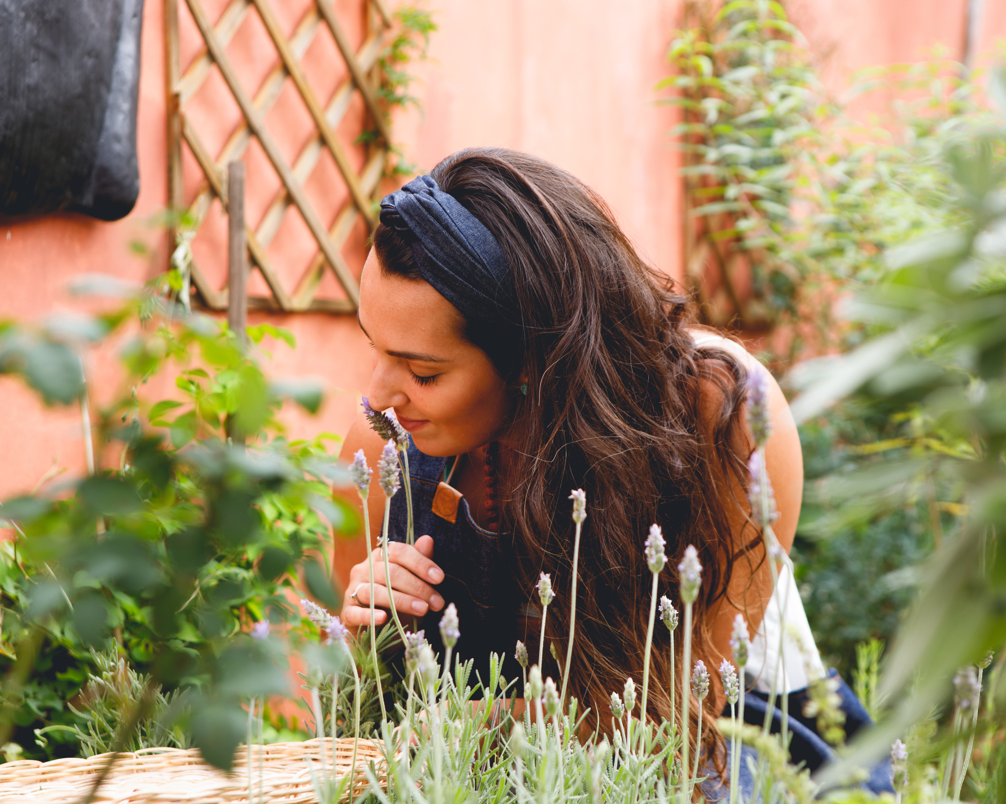 Woman smelling lavender in herb garden