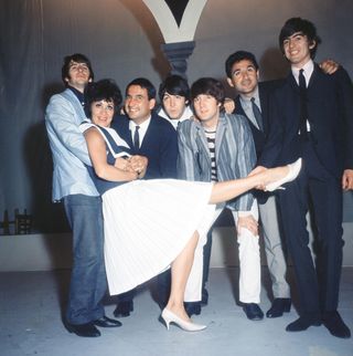 Chita Rivera posing with The Beatles