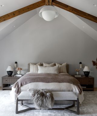 A neutral, organic modern bedroom with layered textiles