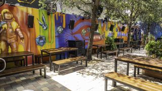 The vibrantly colored outdoor patio at the Vibe at Brick Miami Gets a Dramatic Boost via E11EVEN Sound by DAS Audio