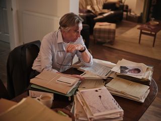 Stephen: DCI Clive Driscoll (Steve Coogan) sits at his table at home, surrounded by the original case files from the Stephen Lawrence murder investigation