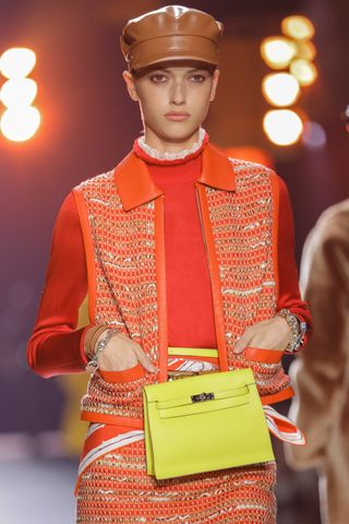 a model carries an authentic hermes bag on the runway in new york city