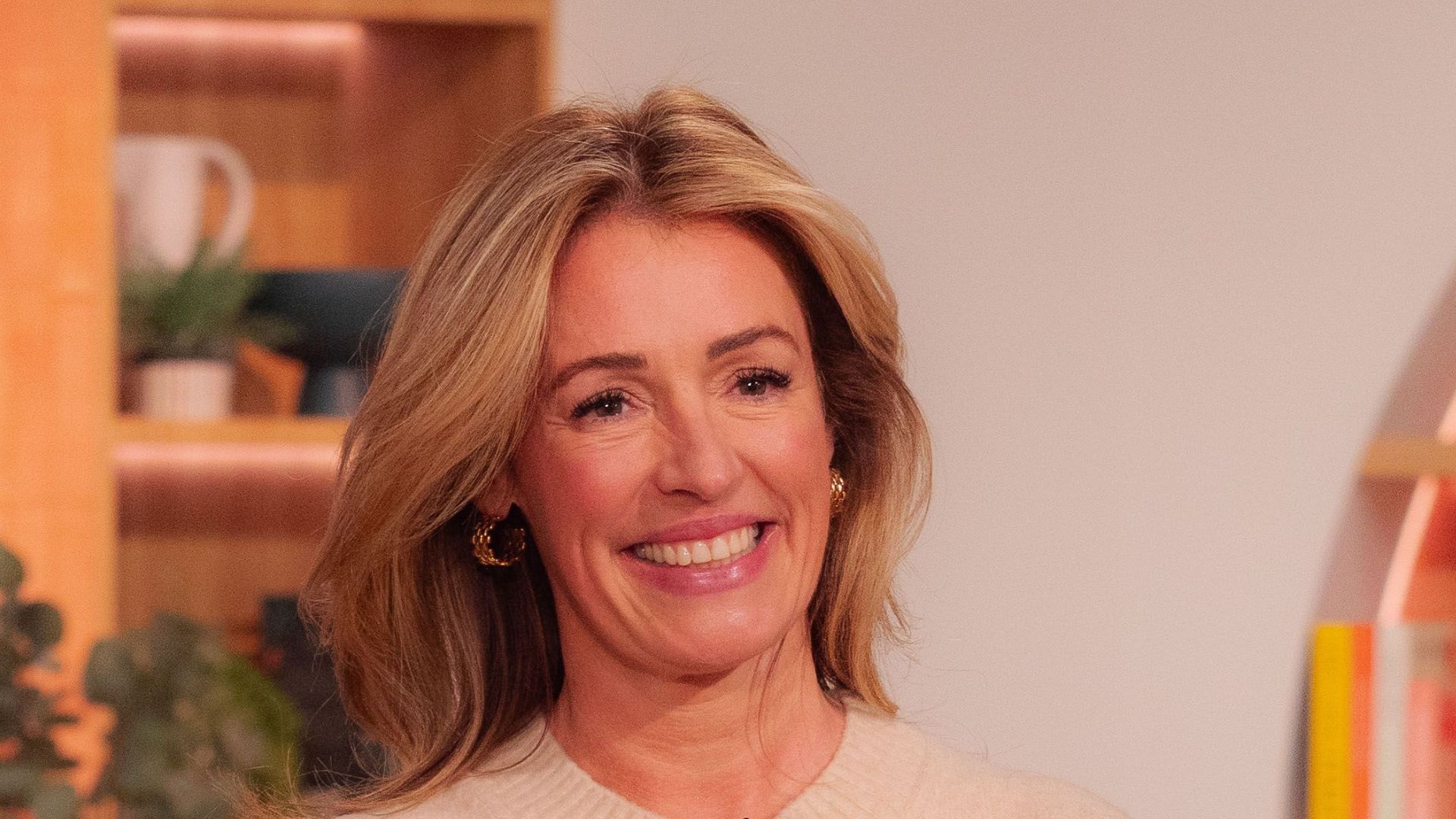 Cat Deeley wears a gold skirt, ecru knit from Reiss and Zara