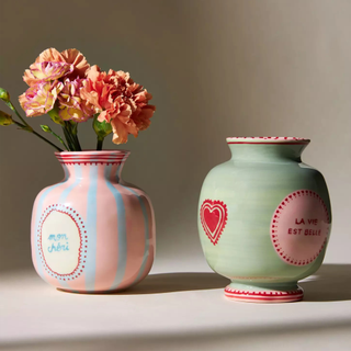 Duo of pink, red, and pastel green decorated vases with hearts and French sayings