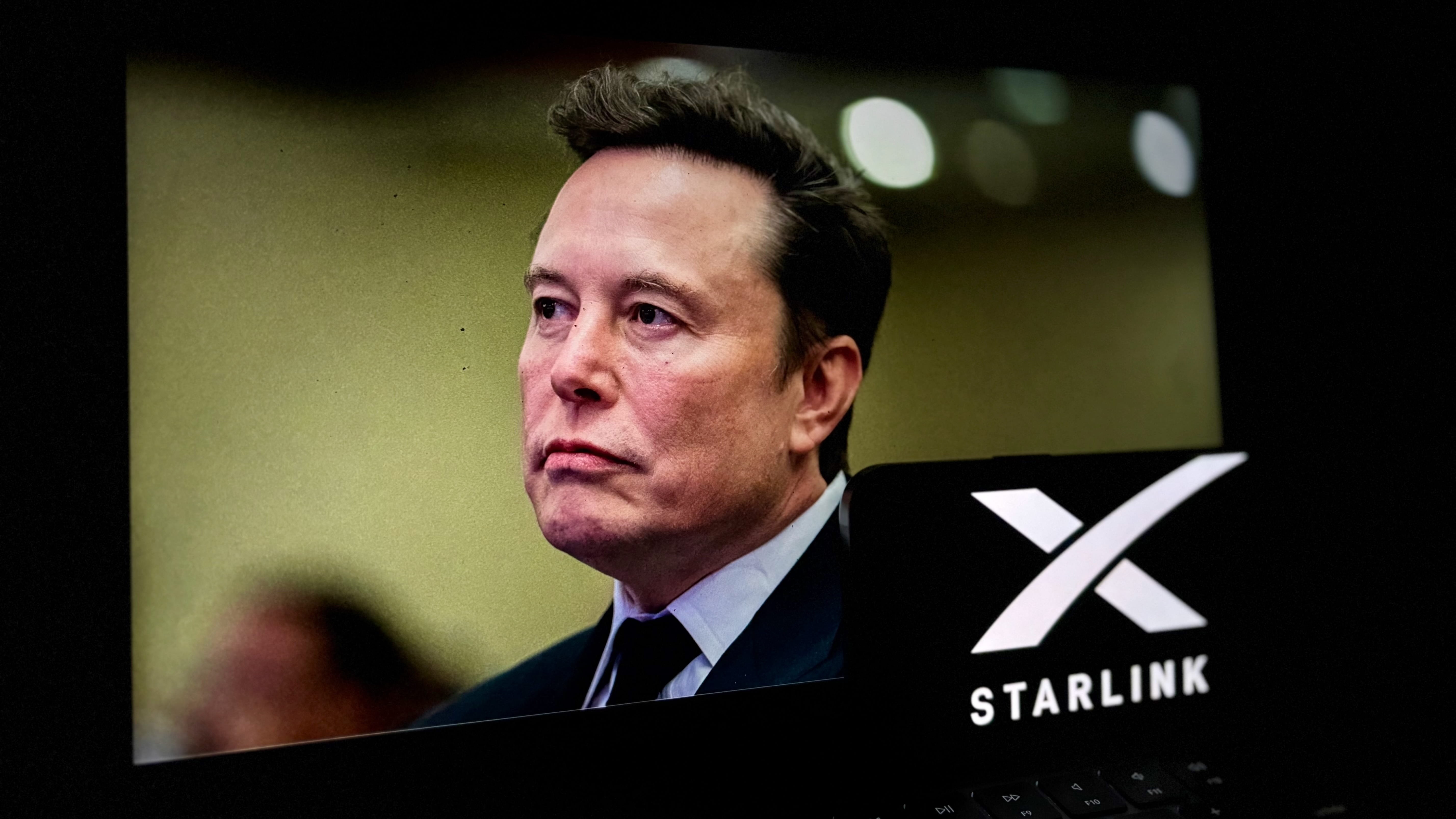 Elon Musk's face behind the Starlink logo