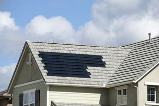 solar roof tiles on grey roof of house