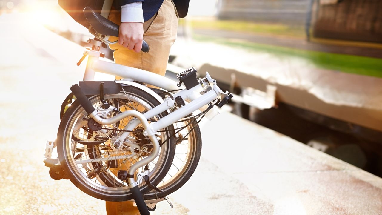 Man holding a folding bike