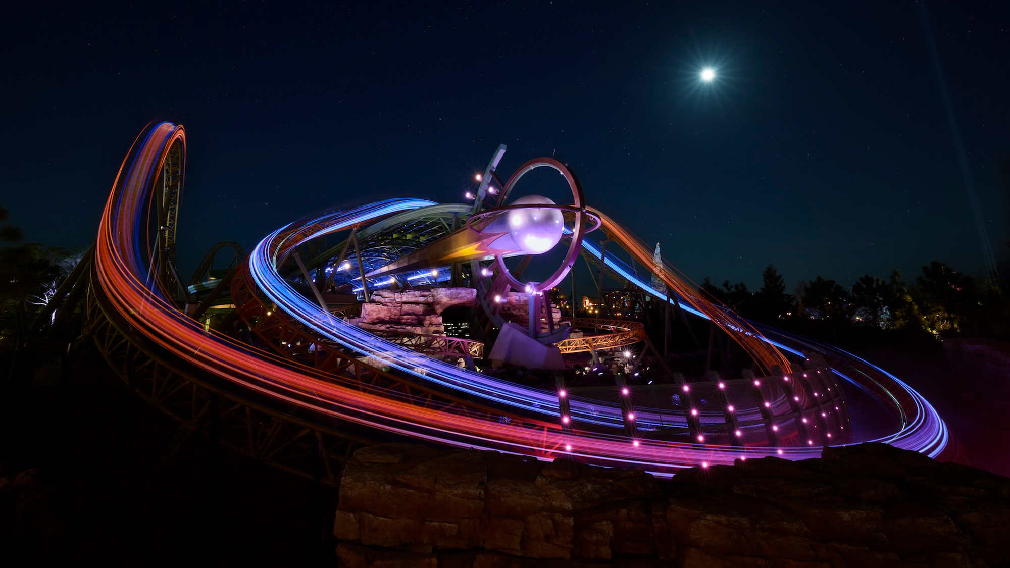 Stardust Racers at night in Celestial Park Epic Universe all lit up.