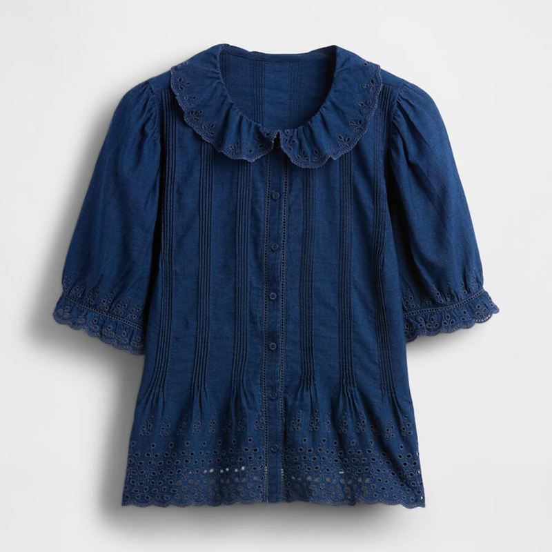 a blue denim short sleeve blouse with broderie anglais detailing from Doen x Gap