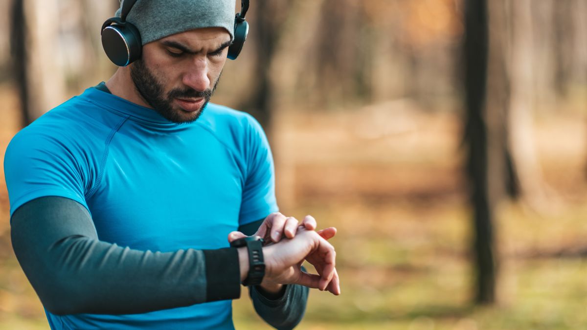 Man checking sports watch outdoors