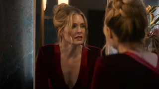 Violet looking in bathroom mirror in Drop