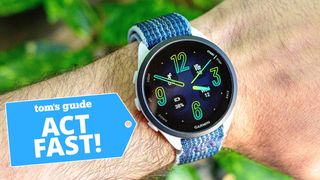 Close-up of the Garmin Forerunner 165 on a user's wrist next to an "act fast!" deals badge