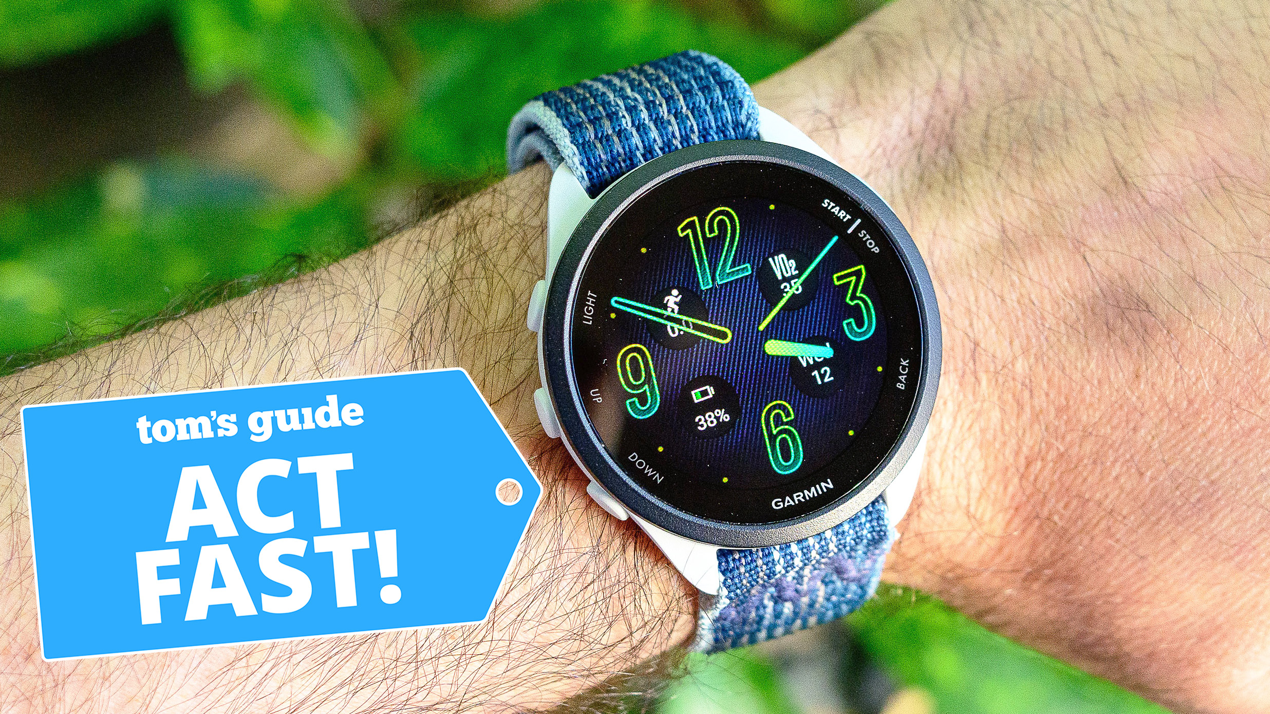 Close-up of the Garmin Forerunner 165 on a user's wrist next to an "act fast!" deals badge