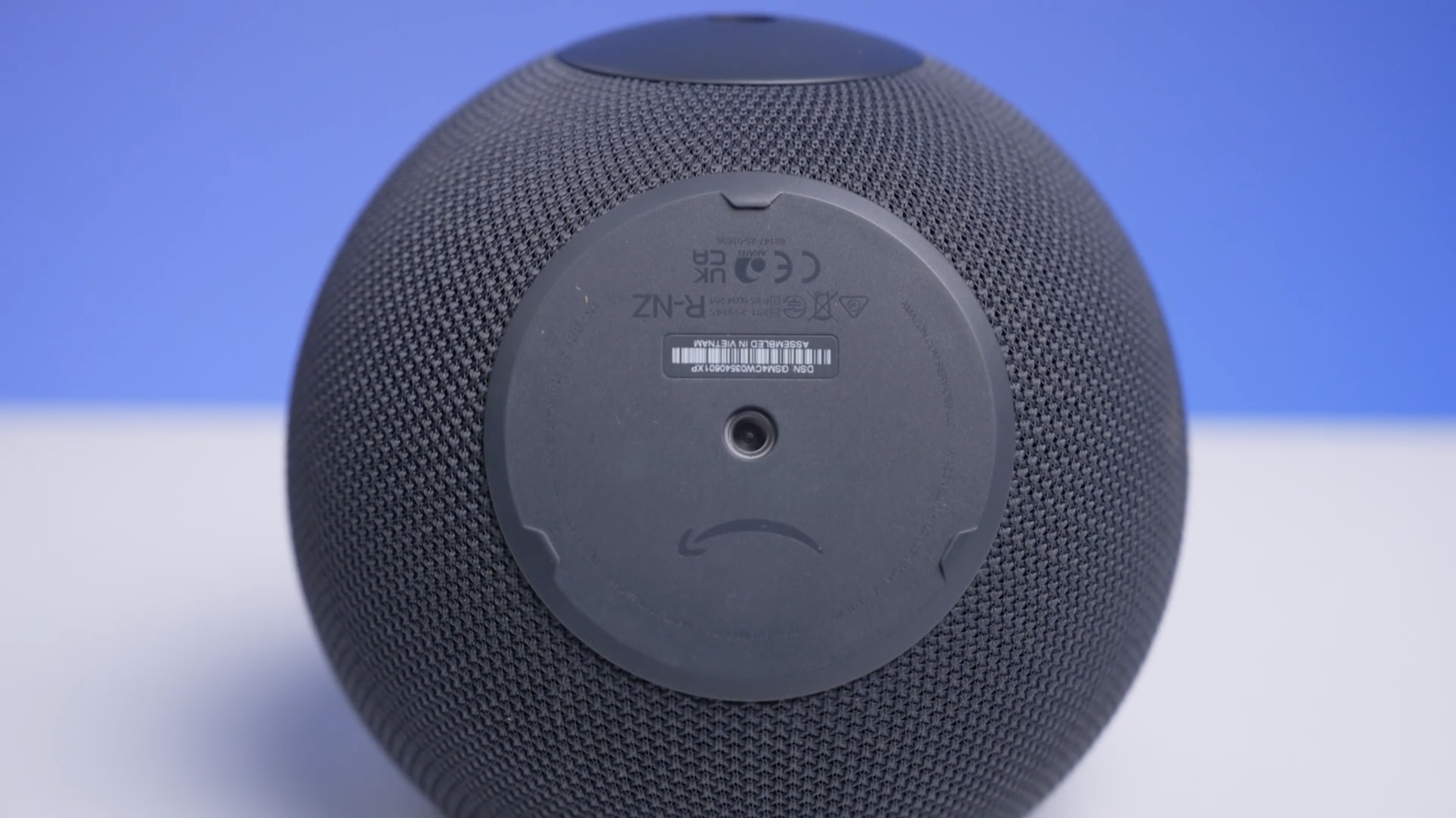 Echo Studio on a white table with a blue background