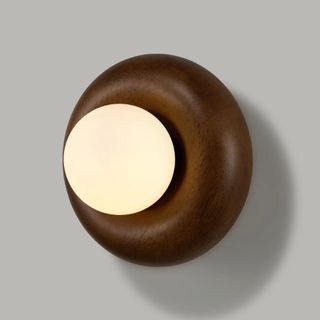 A semi flush, spherical wall sconce 