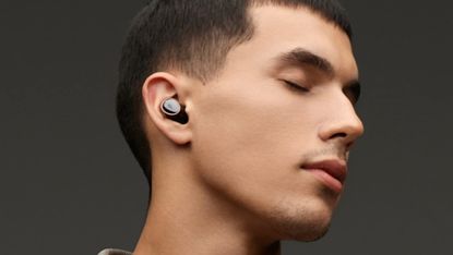 1More Evo review: man wearing true wireless earbuds