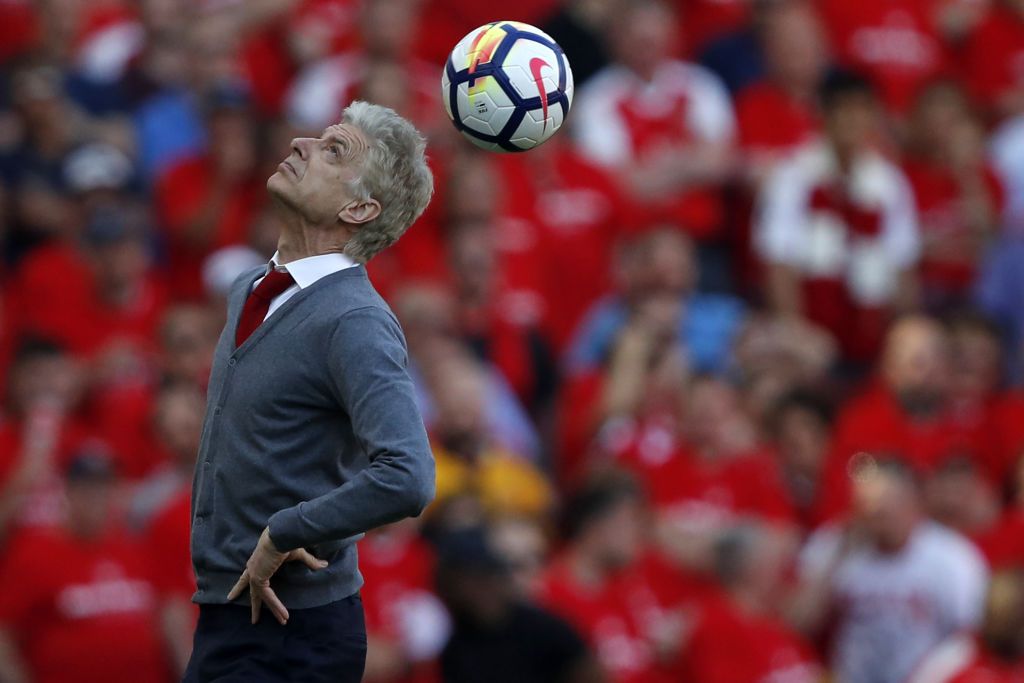 Arsenal&#039;s French manager Arsene Wenger heads the ball back into play after it is returned from the crowd during the English Premier League football match between Arsenal and Burnley at the Emirates Stadium in London on May 6, 2018. - Arsene Wenger bids farewell to a stadium he helped to build in more ways than one when he leads Arsenal at the Emirates for the final time at home to Burnley on Sunday. Wenger&#039;s final season after 22 years in charge is destined to end in disappointment after Thursday&#039;s Europa League semi-final exit.