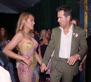 Blake Lively and Ryan Reynolds hold hands at the premiere for It Ends With Us.