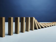 a line of dominoes that are falling over while others remain standing