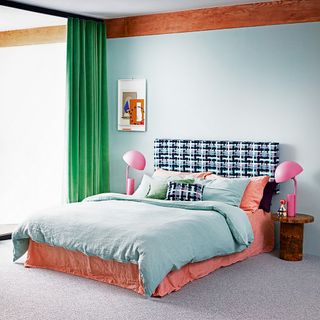 blue bedroom with carpet flooring and green curtains