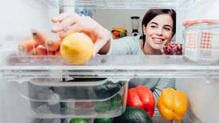 Woman looking inside fridge
