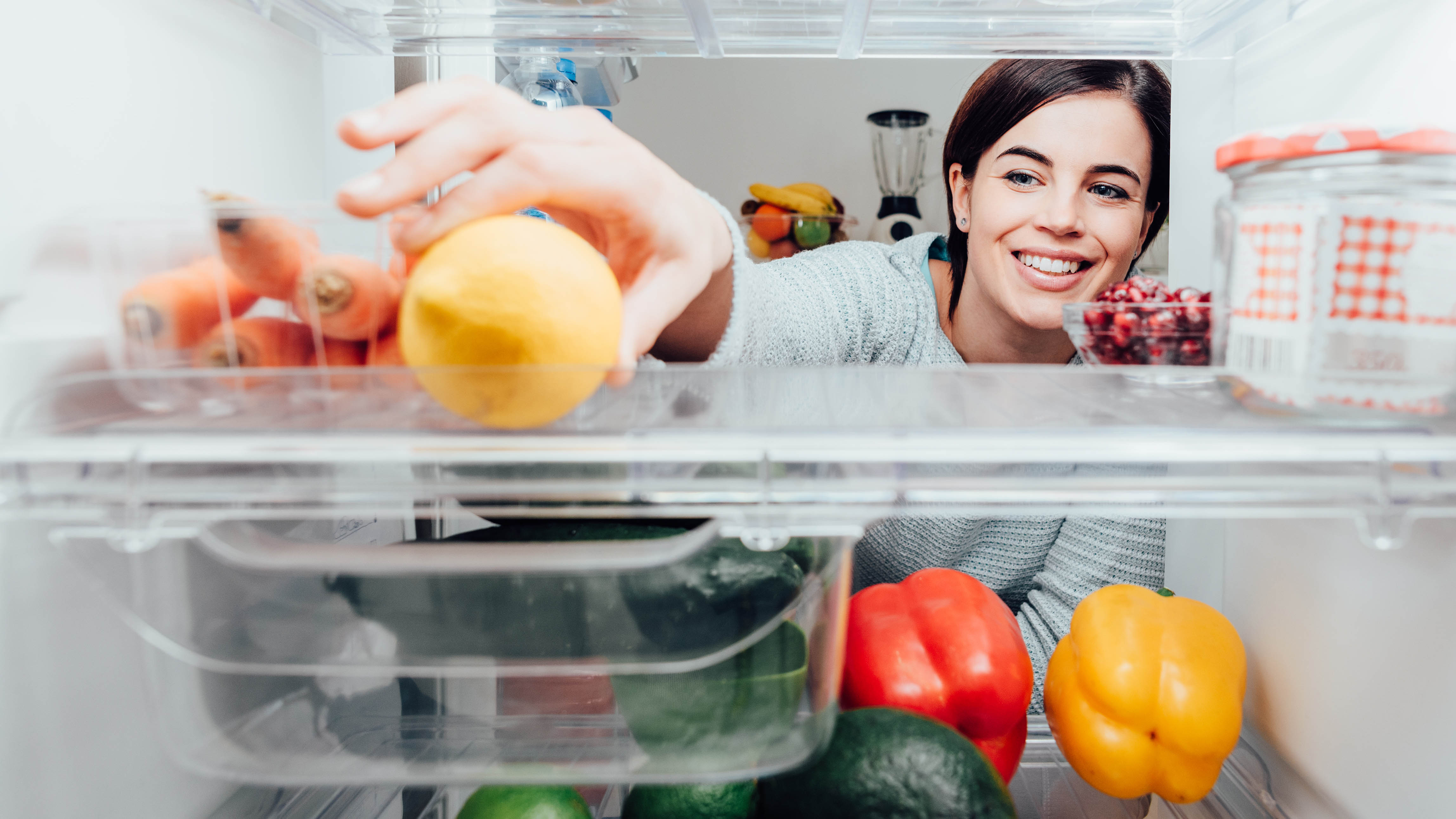 Woman looking inside fridge