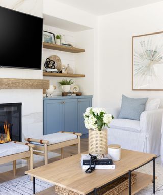 living room with white walls, blue decor and wood accents