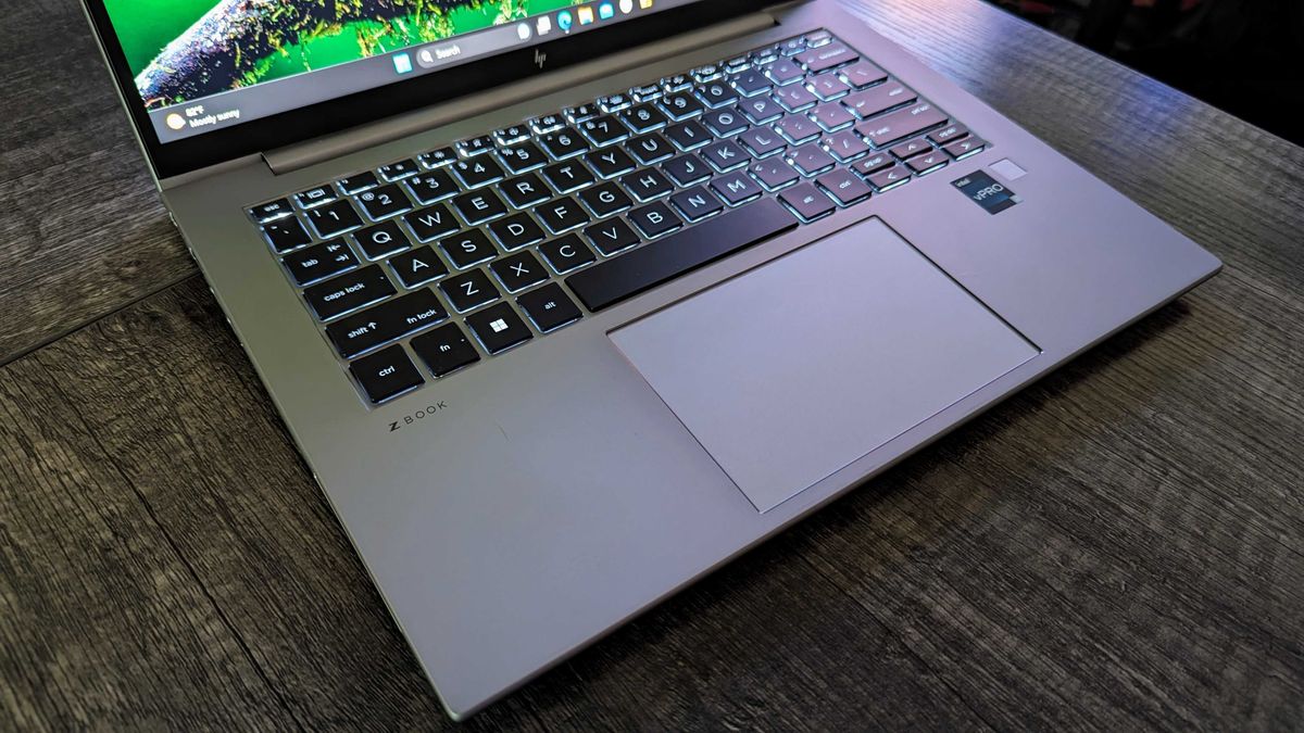 Image of the HP ZBook Firefly 14&quot; (G10) open on a desk, showing the backlit keyboard, touchpad, and fingerprint sensor close up.