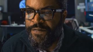 Ice Cube stares at a computer screen which is reflected in his glasses