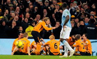 Jimmy Bullard gives a mock team talk to his Hull team-mates after scoring against Manchester City in 2009.