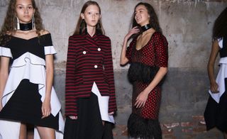 Fashion models with a knit dress and large dangling earrings