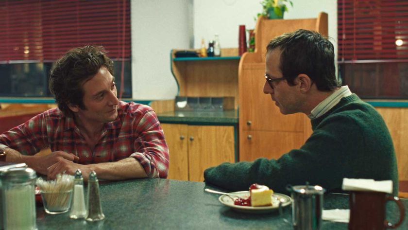 Jeremy Allen White as Bruce Springsteen and Jeremy Strong as John Landau in a diner in a scene from Deliver Me From Nowhere