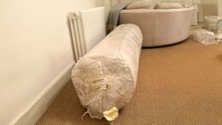 Button & Sprung Southdown mattress rolled on the floor